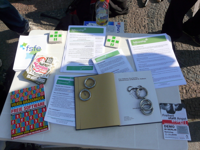 Picture showing several Fellowship leaflets, Richard Stallman's book
Free Software Free Society, and plussy stickers on a
table