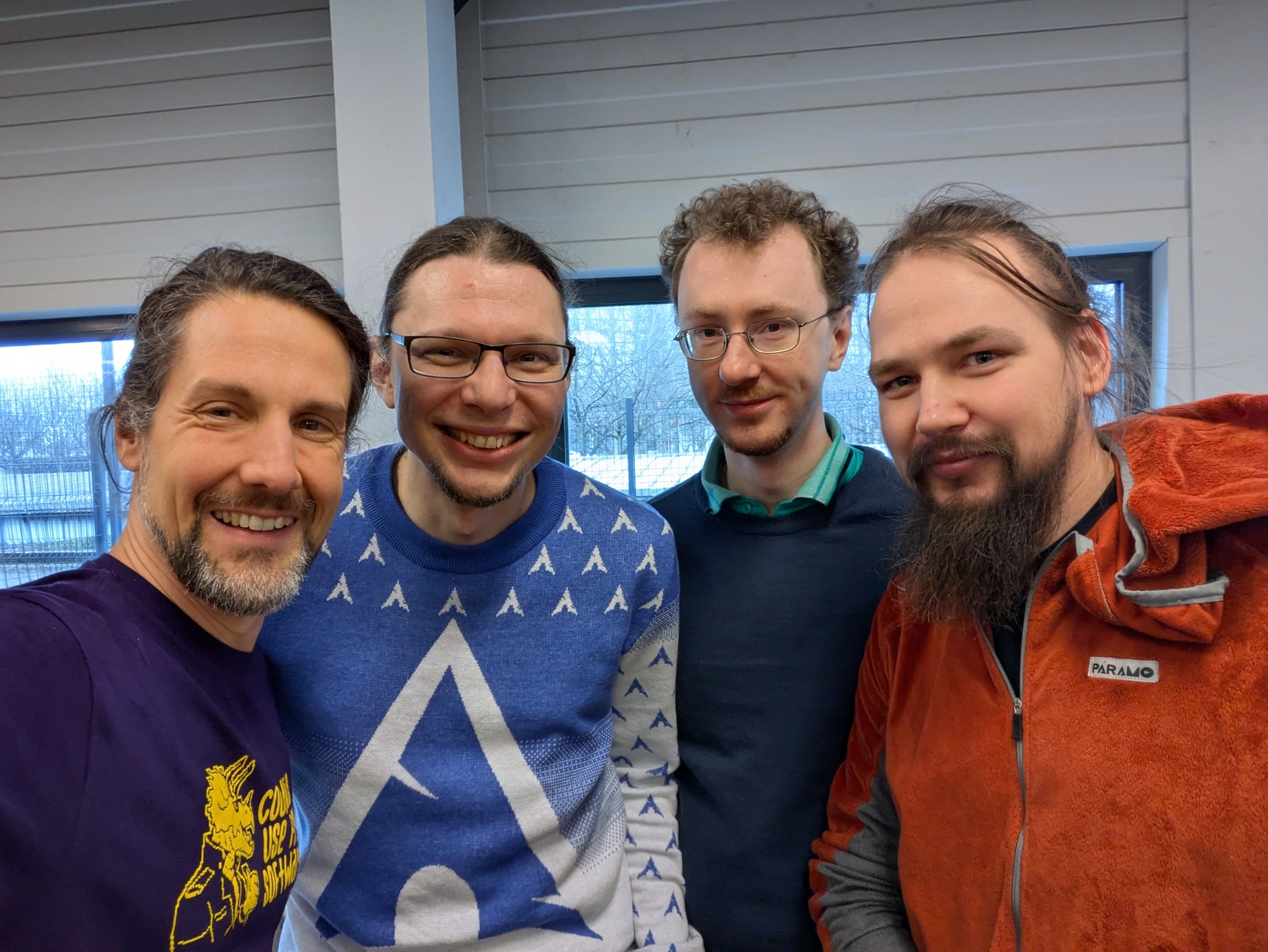 Myself, Arch Project Leader Levente, ArchWiki maintainer Ferdinand, and FSFE's vice president Heiki at FOSDEM 2025 after I handed them over some hacker chocolate